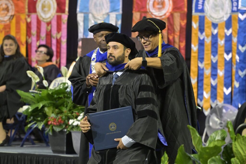 Dr. Yousaf Khaliq being hooded by Dr. Forrest Wang.